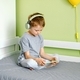 A preschool boy plays a game or watches a video on mobile using headphones. - PhotoDune Item for Sale