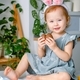 A cute smiling cheerful toddler girl dressed up bunny ears holding easter gift chocolate eggs. - PhotoDune Item for Sale