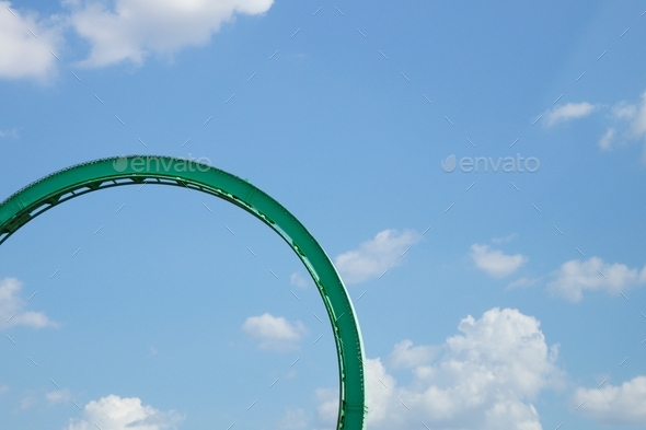 Roller coaster loop against blue sky colorful minimalism