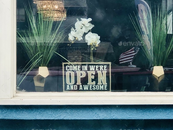 Store sign that says “come in we’re open and awesome “ open store