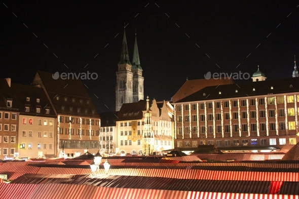 View of Christmas market tents and architecture of Nuremberg at night