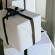 Wrapped packages in white with black ribbons are stacked - PhotoDune Item for Sale
