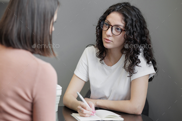 female psychologist holds a meeting with a patient. Help with anxiety and stress, mental health and