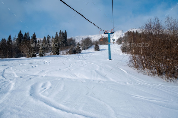 view from old chair lift at ski resort Stock Photo by petruninsphotos