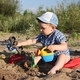 Little boy playing with sand on the beach - PhotoDune Item for Sale