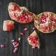 Pomegranate sections on wood table - PhotoDune Item for Sale