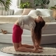 A young woman is doing yoga exercise in a cozy home interior, healthy lifestyle. - PhotoDune Item for Sale