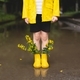 a boy in a yellow raincoat and yellow rubber boots - PhotoDune Item for Sale