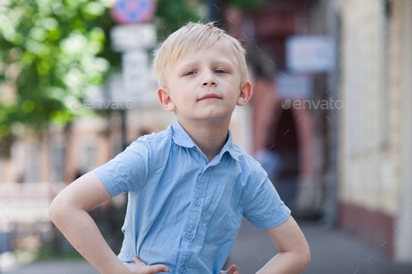 little boy walking on the street - Stock Photo - Images
