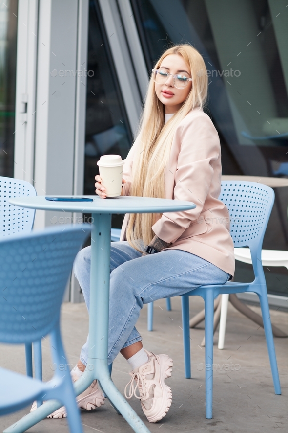 woman drink coffee in street cafe - Stock Photo - Images