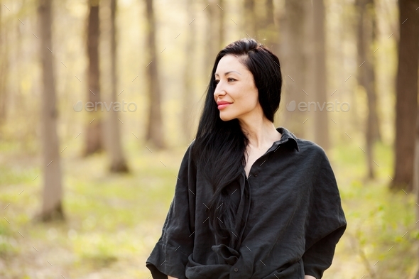 beautiful brunette girl in the forest. - Stock Photo - Images