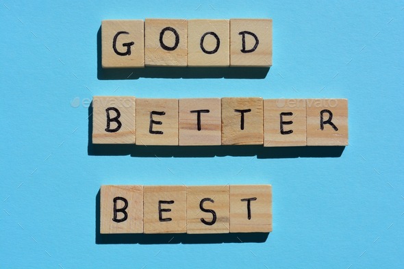 Good, Better, Best, in wooden alphabet letters on a blue background, motivational phrase.