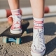 Girl on a skateboard.  Legs in sneakers close-up - PhotoDune Item for Sale
