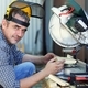 portrait of a handyman working on a miter saw - PhotoDune Item for Sale