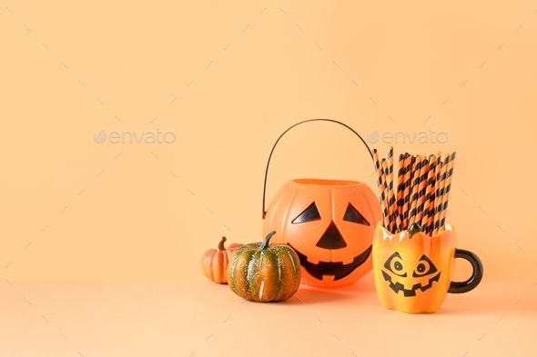 Halloween festive party decorations, candy bowl, pumpkins, funny mug with drinking straw