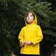 a boy in a yellow raincoat and yellow rubber boots - PhotoDune Item for Sale