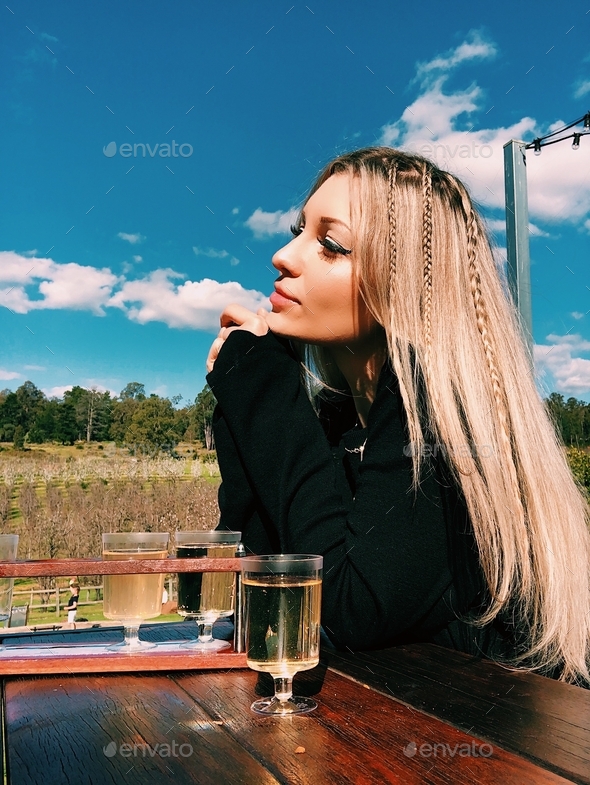 Beautiful blonde girl drinking cider - Stock Photo - Images