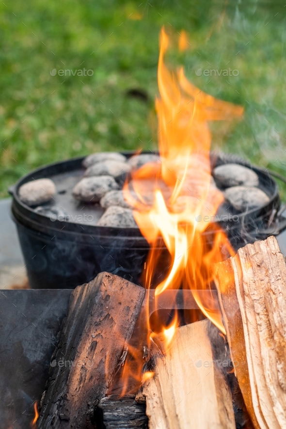 Cooking in cast iron camp oven with charcoal bbq beads. Camp cooking