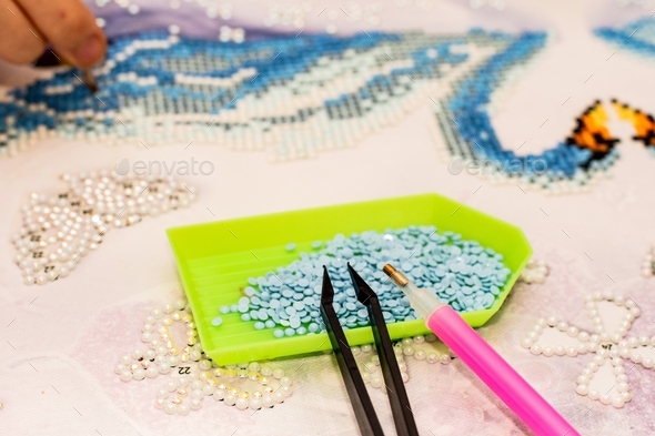 Diamond mosaic. Diamond embroidery. Diamond painting craft with acrylic rhinestones