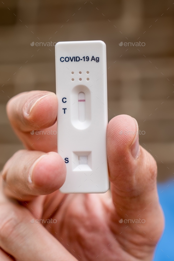 Hand holding negative Covid-19 Antigen Rapid test result. Rapid diagnostic test