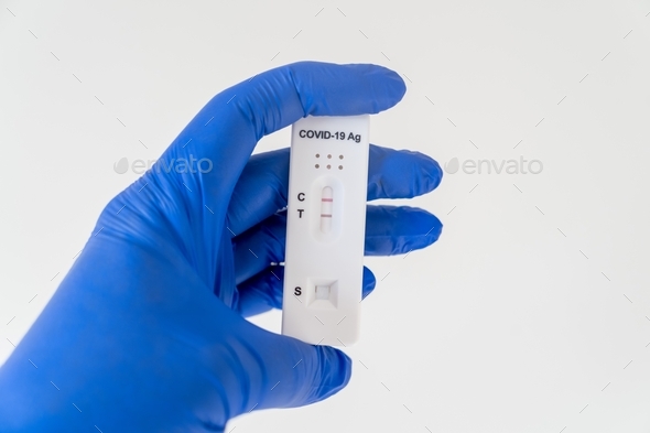 Hand nurse holding positive Covid-19 Antigen Rapid test result. Medical rapid diagnostic test