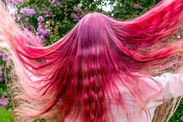 Teenage girl with bright raspberry pink ombré hair color. Semi permanent hair dye. Express yourself