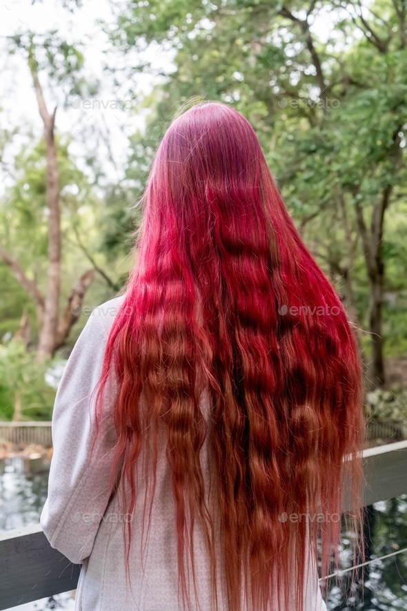 Teenage girl with bright raspberry pink ombré hair color. Semi permanent hair dye