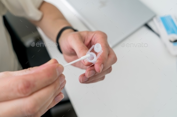  Man doing Covid-19 Antigen Rapid test at home. Rapid diagnostic test kit nasal swab in progress