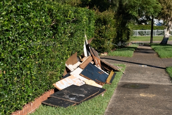 Household rubbish items put near the sidewalk for council waste collection. Illegal dumping