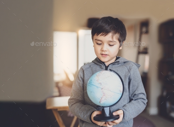 Portrait Kid Is Looking At A Globe, School Boy Learning About Geography ...