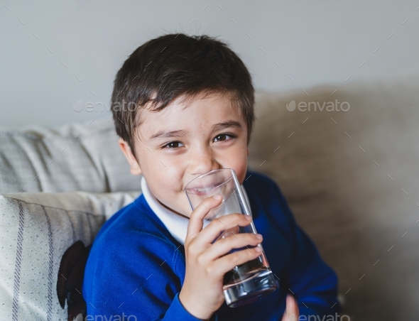 Boy drinking soda or soft drink with glass,Child drinking cold fizzy ...