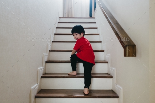 Boy climbing up the stair Stock Photo by wikornr | PhotoDune