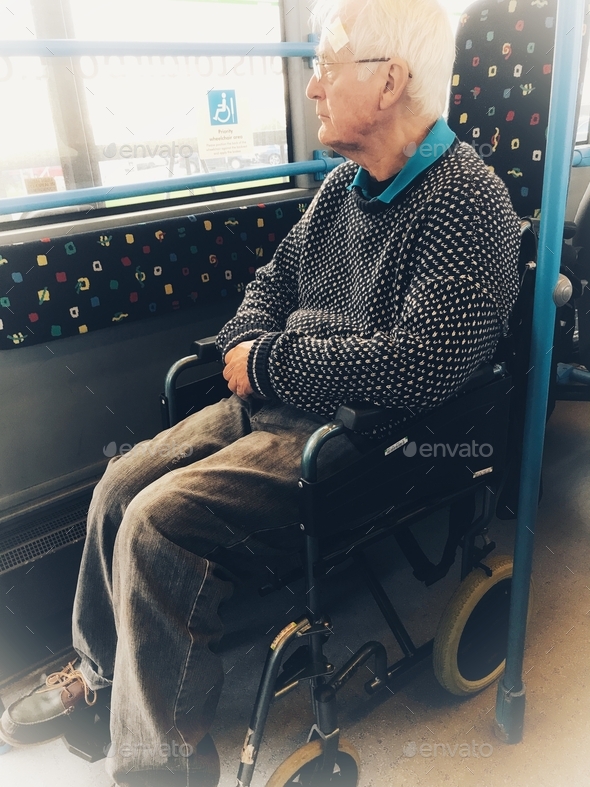 Travelling with a wheelchair, senior man using public transport
