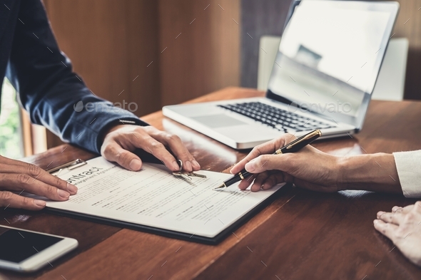 Sales manager filing keys to customer after signing rental lease contract of sale purchase agreement