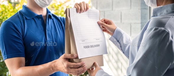 Asian delivery man showing grocery bag and food delivery bill to customer to sending product