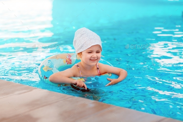 Cute toddler girl swimming in pool. Family vacation in resort. Nice ...