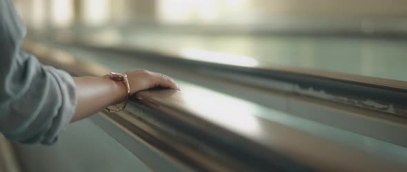Woman's Hand Lies on the Railing of the Escalator, Slow Motion alt