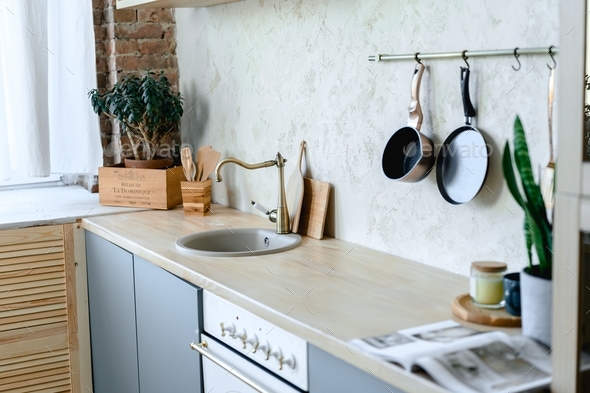 cozy kitchen interior in gray colors and wooden decor Stock Photo by