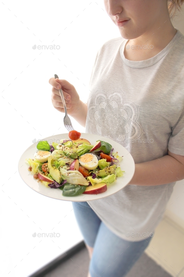 Young lady eating salad for lunch 
 - Stock Photo - Images
