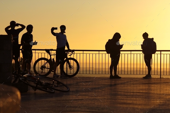 Silhouettes of a group of people at sunrise