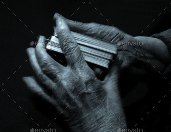 Hands of a mature aged lady shuffling the cards to play UNO with the grandkids - Stock Photo - Images