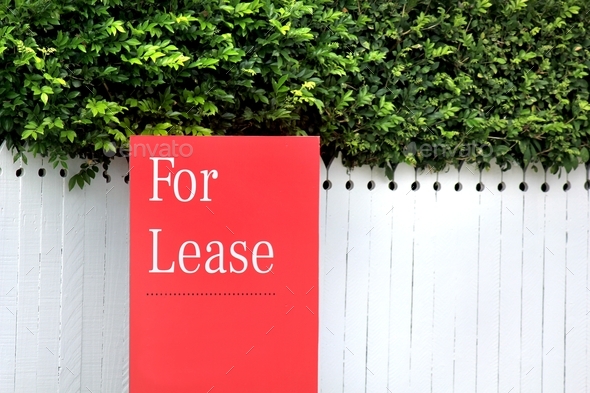 Red For Lease sign on a house in the rental property market
