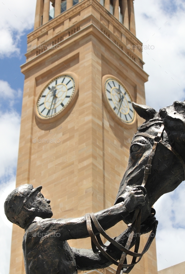 Statue of a man and horse in front of Brisbane City Hall clock tower