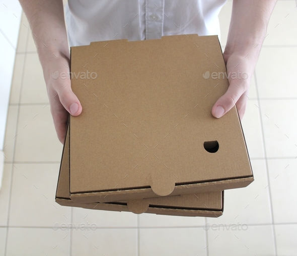 Two cardboard pizza boxes, home delivery, takeout food, recycled paper