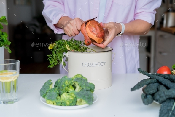 Compost the kitchen waste, recycling at home. Woman putting vegetables leftovers into compost bin