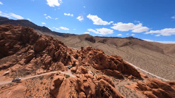 Flying Up Colorful Rock Desert Canyon Campsite FPV Drone Speed Fast Perspective alt