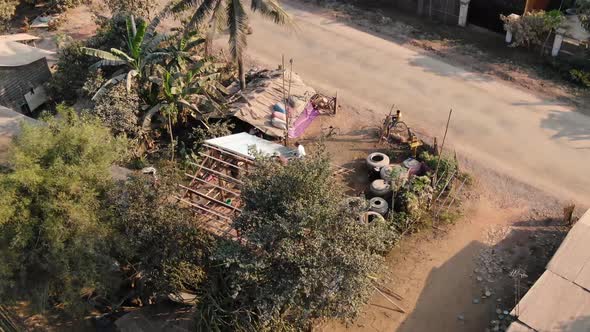 Top view clip of a curious boy on bicycle watching a house construction in a rural area in Battamban alt