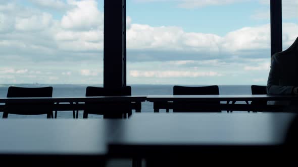 Two Silhouettes Working Sea View in Office alt