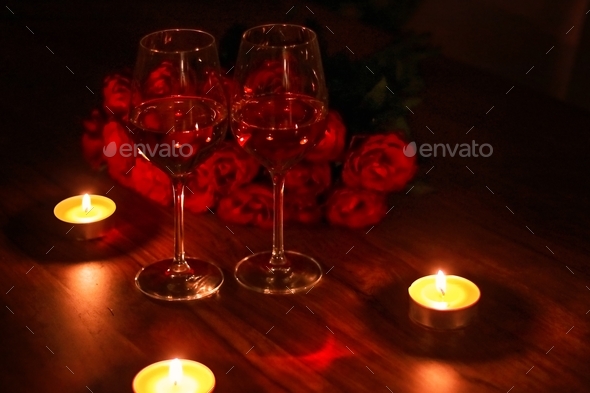 Romantic dinner with candles and wine.