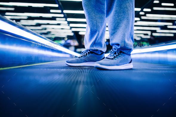 Sneakers on escalator in airport - Stock Photo - Images